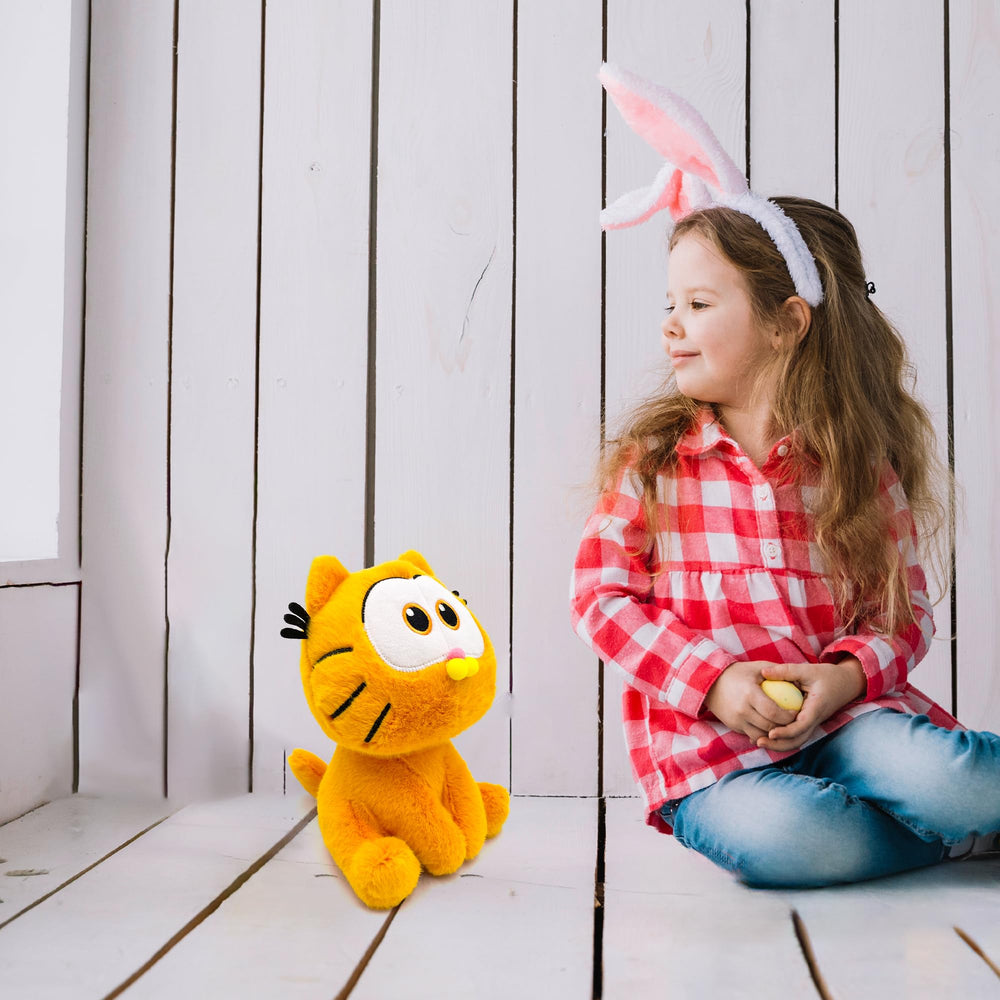 Adenzai Garfield plush on display on a shelf with decor.