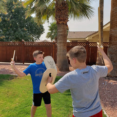 Adventure Awaits wooden toy shield side view highlights easy grip for small hands.