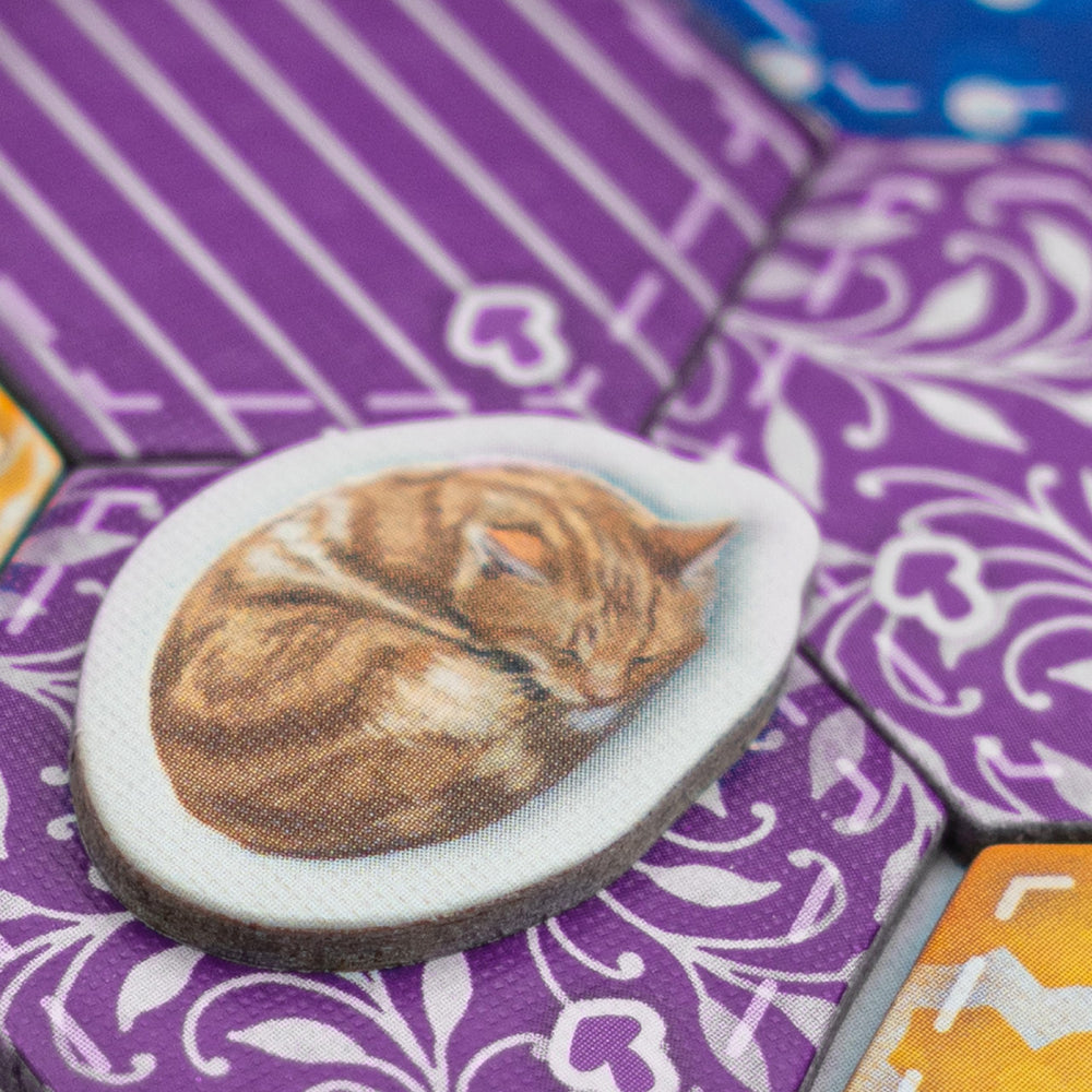 AEG Calico cat enjoying a quilt to attract points and comfort.