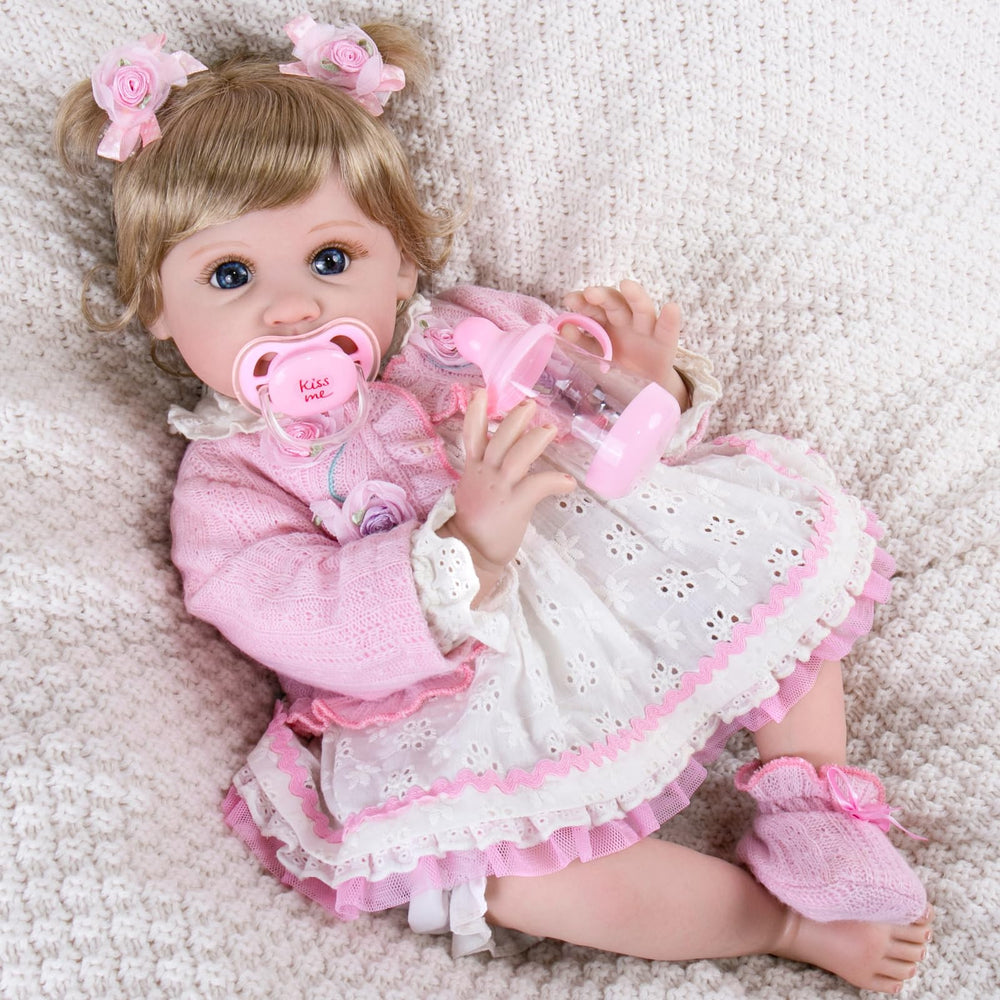 Aori Reborn 22-inch pink-outfit doll showcases dress-up appeal and styling.