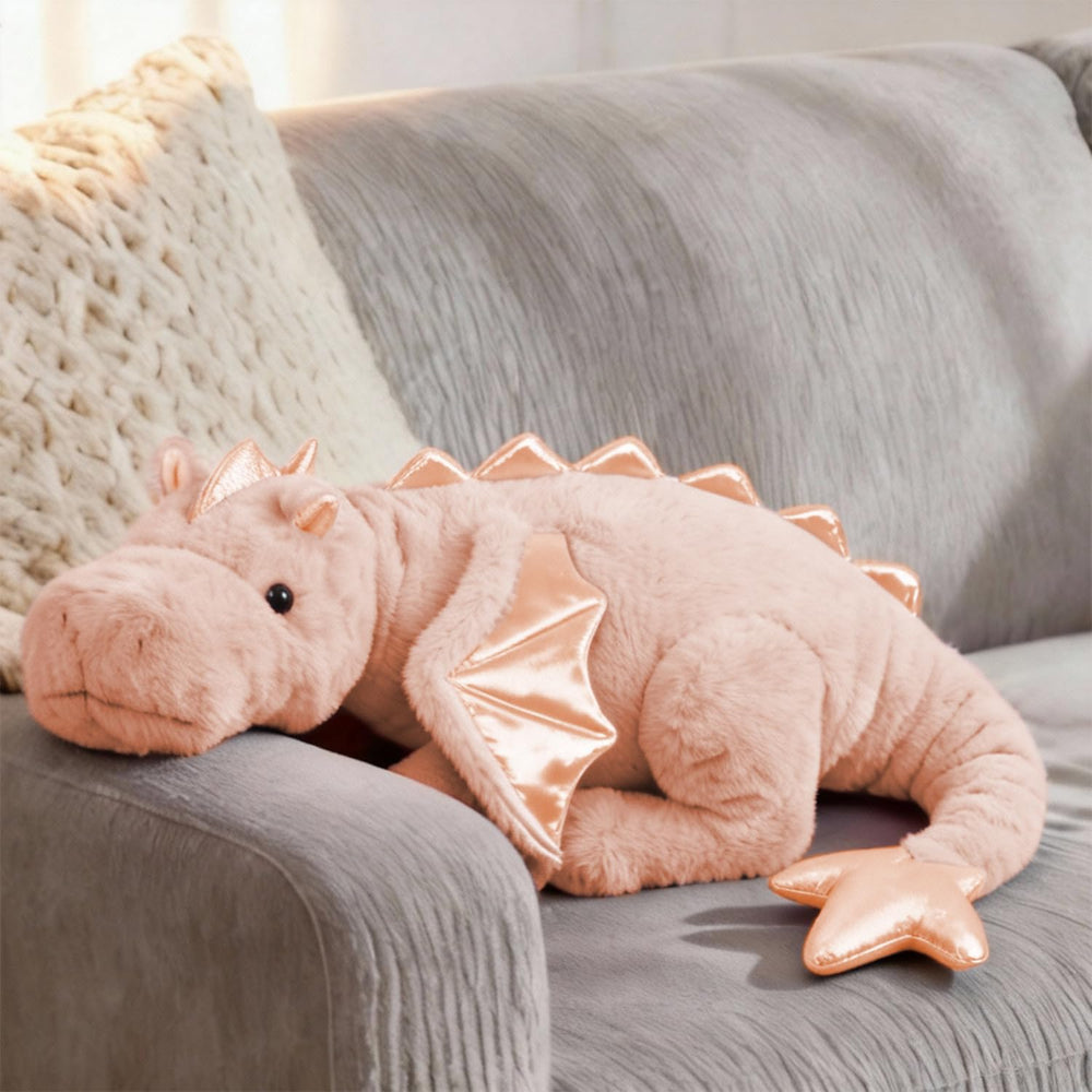 ARELUX pink dragon plush on a bed for cozy decor and cuddle.