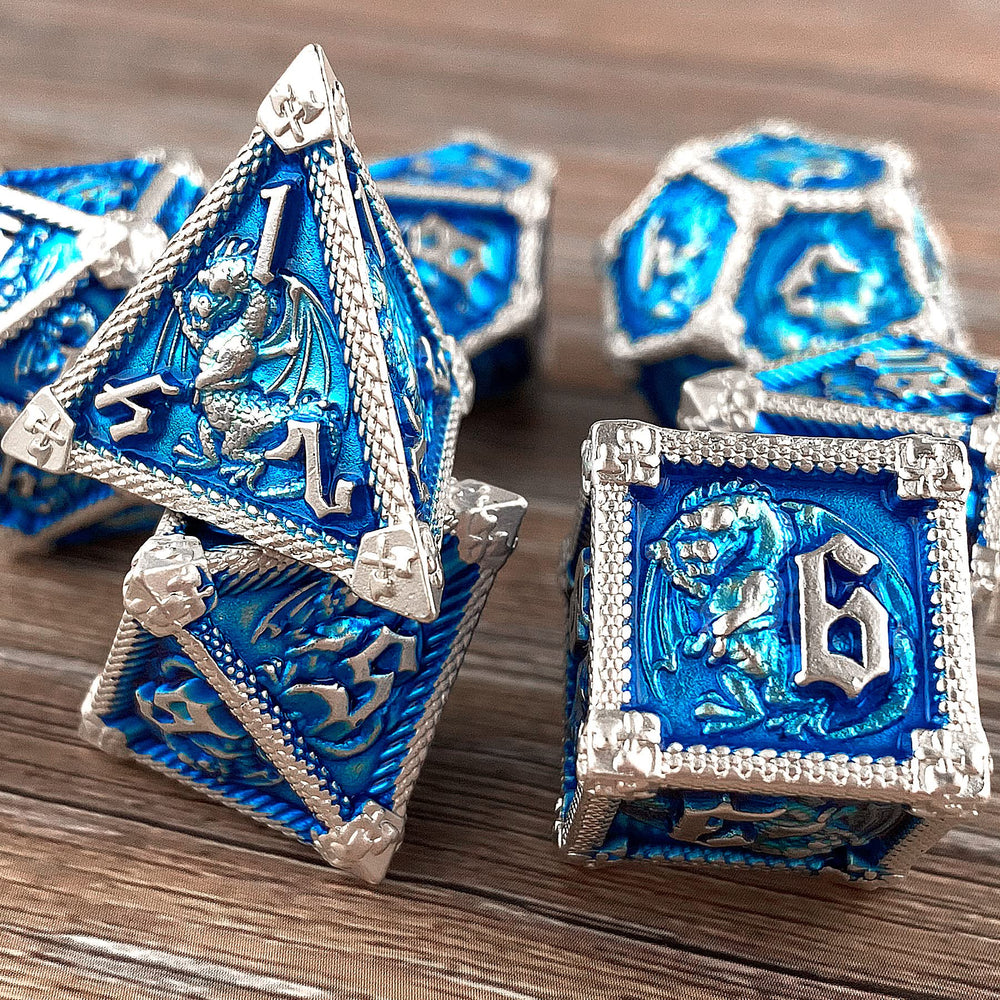 Close-up of D12, D10, D8 metal dice with dragon-inspired design.