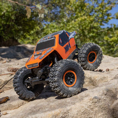 Axial AX24 XC-1 rock-slider LED lights illuminate the path in low light.