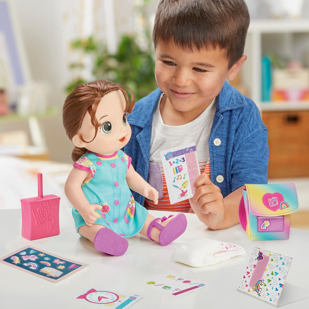Baby Alive Time for School doll drinks from a juice box during pretend meals.