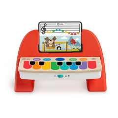 Baby Einstein Cal's First Melodies piano on a wooden surface invites tactile music exploration.