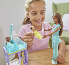 Barbie Careers playset examination table enables pretend checkups.