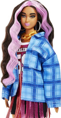 Long crimped pink-streaked hair frames Barbie Extra face for imaginative styling