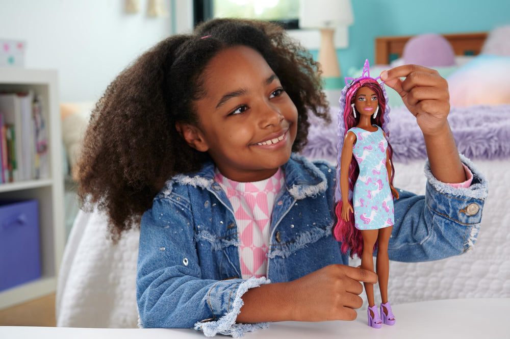 Barbie Fun & Fancy Hair doll wearing a glossy pink minidress and accessories