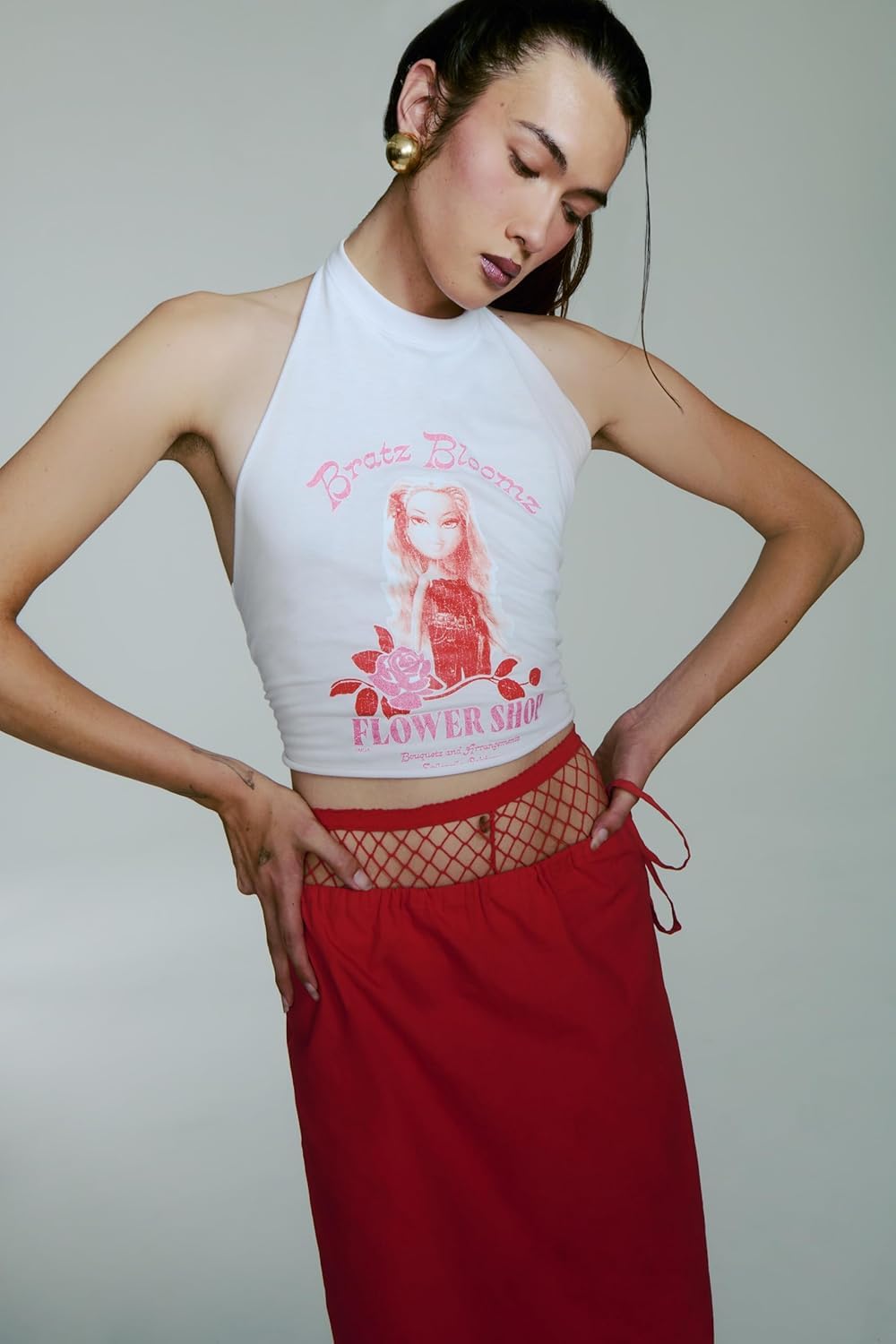 Pink hair bow accents highlight pastel glam styling.