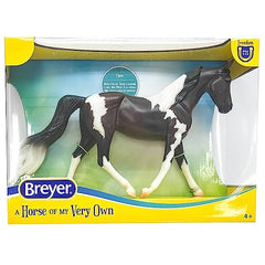 Breyer Pinto side view highlighting detailed mane and natural pose for display.
