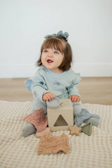 Brooklyn Neutral toddler pull toy alongside shape sorter for hand-eye coordination
