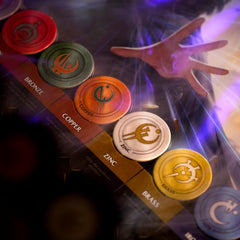 Brotherwise Mistborn game components layout with cards, tokens, and boards.