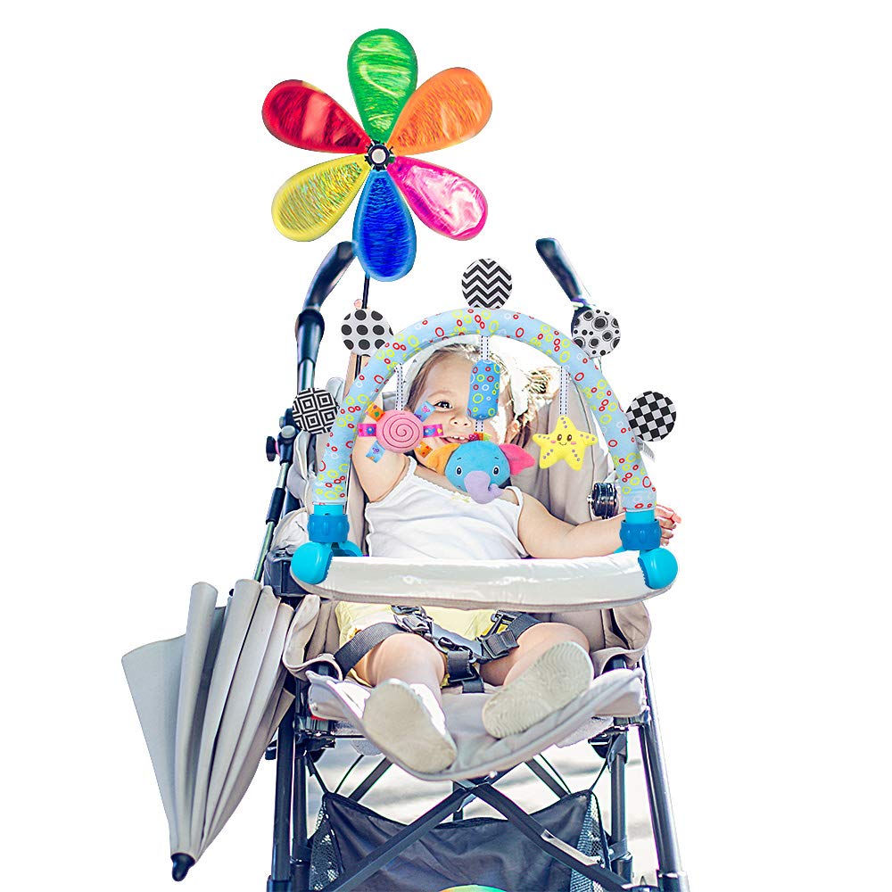 Caterbee pram activity bar with plush toys engages baby outdoors.