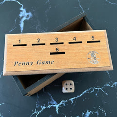 CBLKUS Penny Game box with coins arranged for strategic drops
