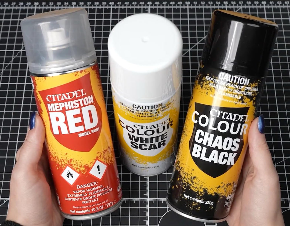 Citadel Chaos Black undercoat spray creates a neutral base for vibrant paints on models.