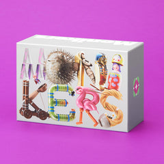 CMYK Monikers card deck closeup emphasizes clues for funny inside jokes.