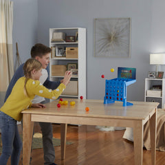 Connect 4 Shots kids playing indoors for active standing-up fun.