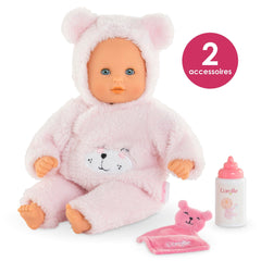 Corolle soft vinyl skin and gentle scent invite curious touch.
