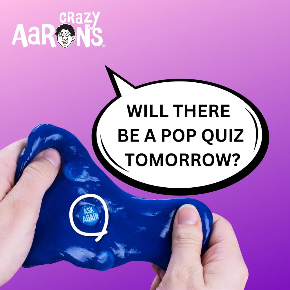 Adult using Crazy Aaron's blue putty for focused desk play.