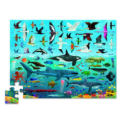 Two kids playing Crocodile Creek Above + Below puzzle on the floor