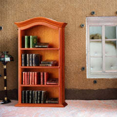 Crtiin 1:12 scale study area in a dollhouse with a book-filled shelf