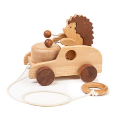 DadCarved Hedgehog pull-along toy with drum-arms promotes rhythm and walking exploration.