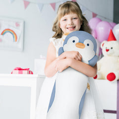 Dalmao penguin hugging pose demonstrates kid-friendly plush for bedtime comfort.
