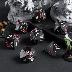 DNDND flower metal dice D6 in matte black with pink flower, sturdy for immersive sessions.