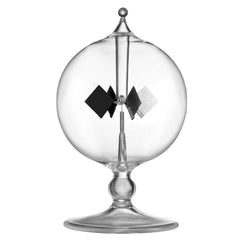DORAMI Clear Crookes Radiometer on a desk, light-powered kinetic decor for workspaces.