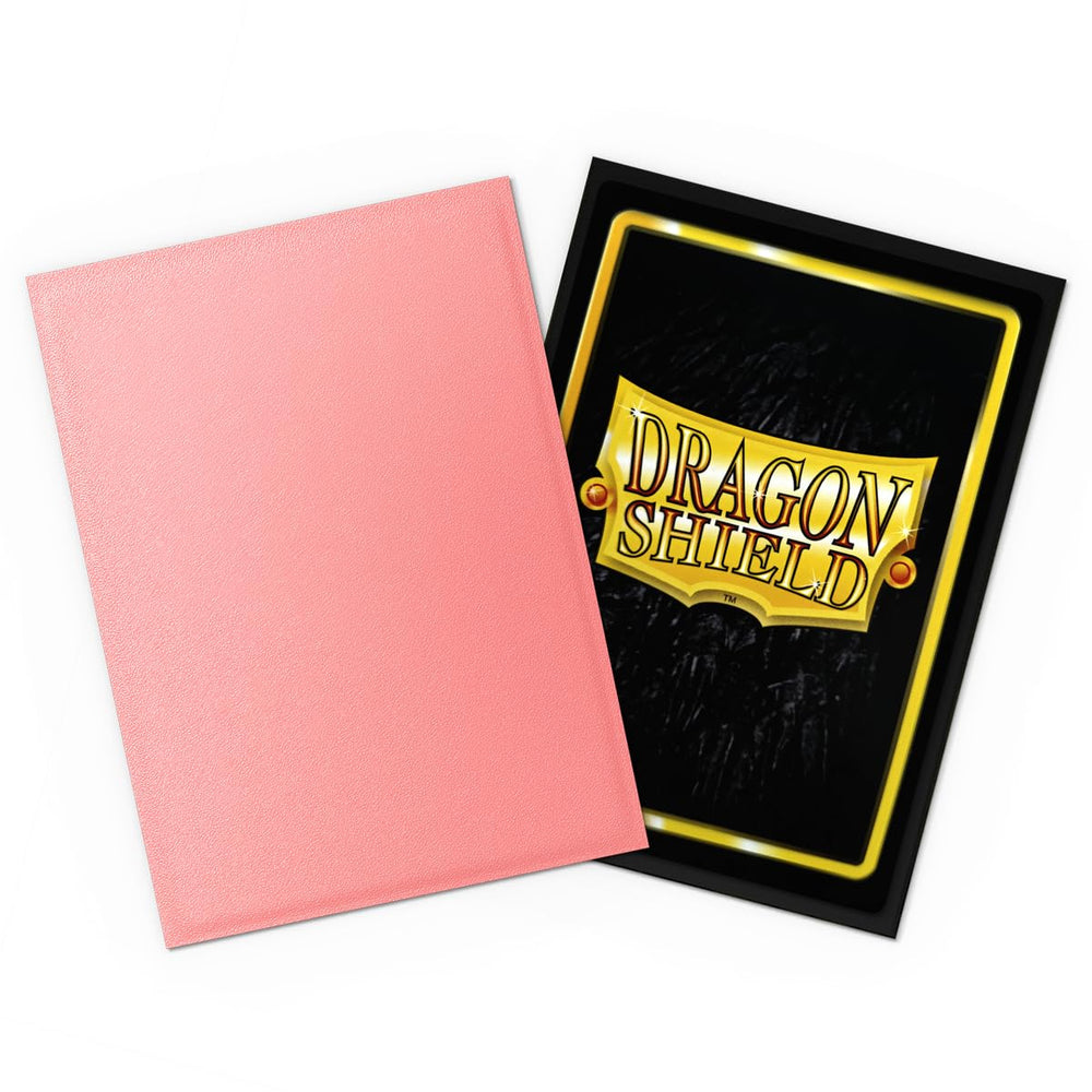 Dragon Shield Peach sleeves in hand highlighting easy shuffle and durable design.