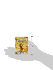 Hand holding Dragon Shield yellow sleeves for on-the-go card protection.