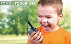 ekids Batman walkie talkies outdoor play scene hints at extended range in ideal conditions.