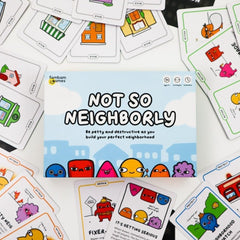 Two to four players around a table playing Not So Neighborly energetically.