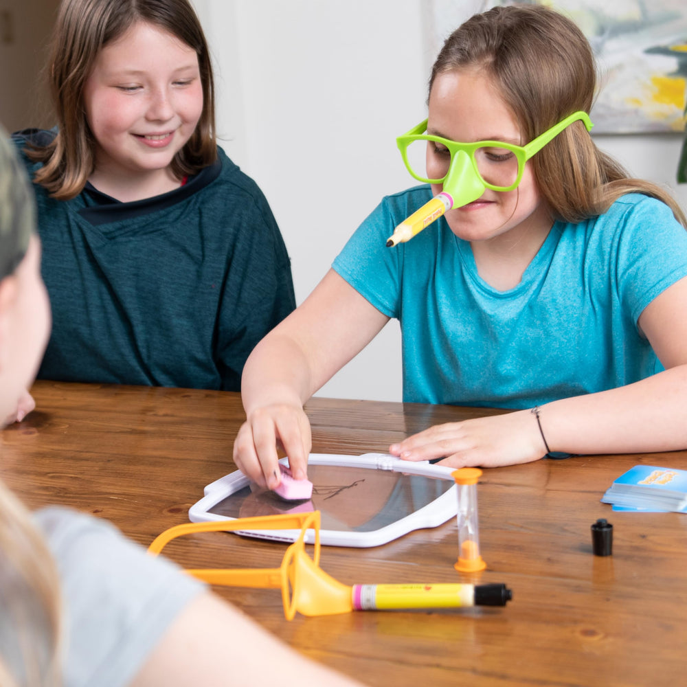 Fat Brain Toys Pencil Nose family night scene showcases inclusive fun for 4 players and up.