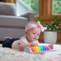 Baby hands explore colorful bells to build hand-eye coordination