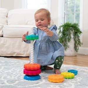 Young child stacks SpinAgain discs in a colorful tower