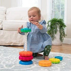 Young child stacks SpinAgain discs in a colorful tower