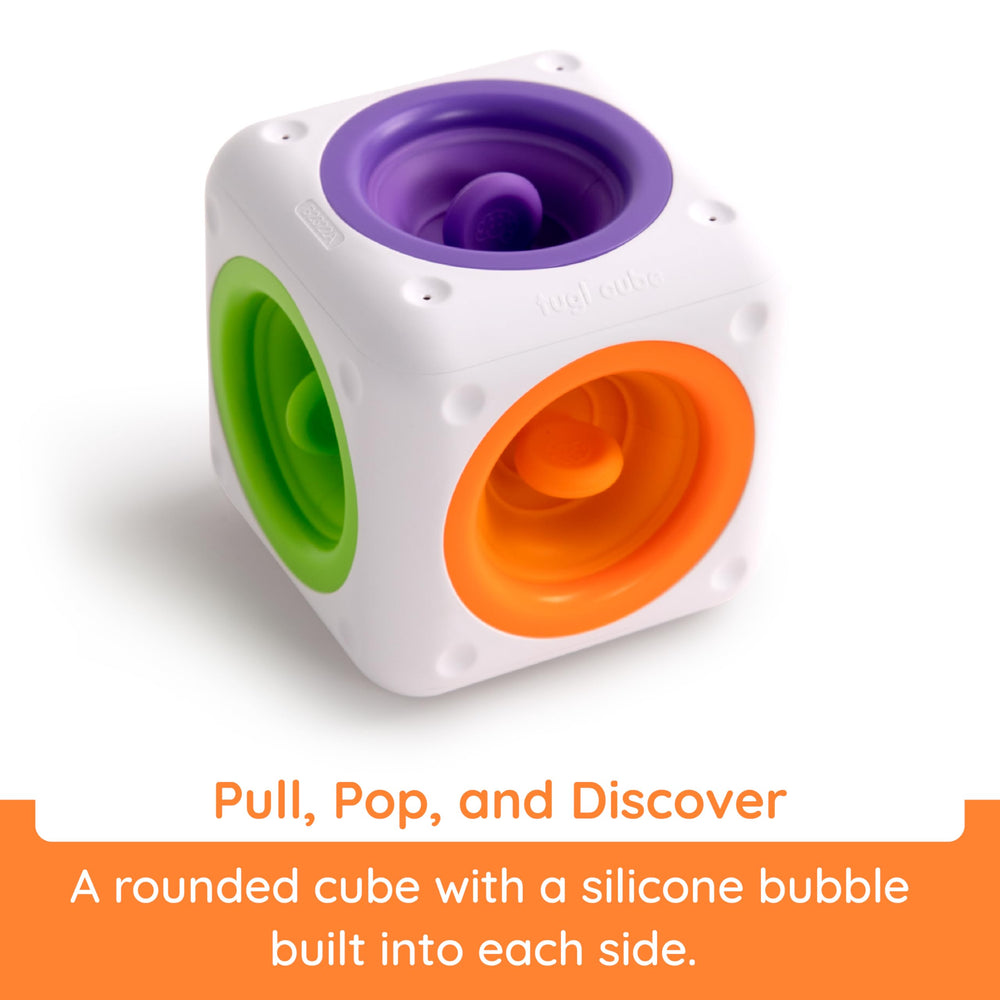 Fat Brain Toys Tugl Cube demonstrating pulling and pushing action for fine motor practice.