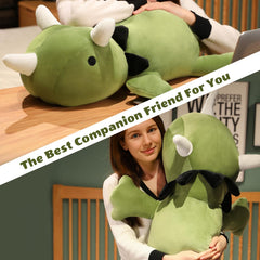Finebee weighted dinosaur plush shown in a cozy bedroom setup.