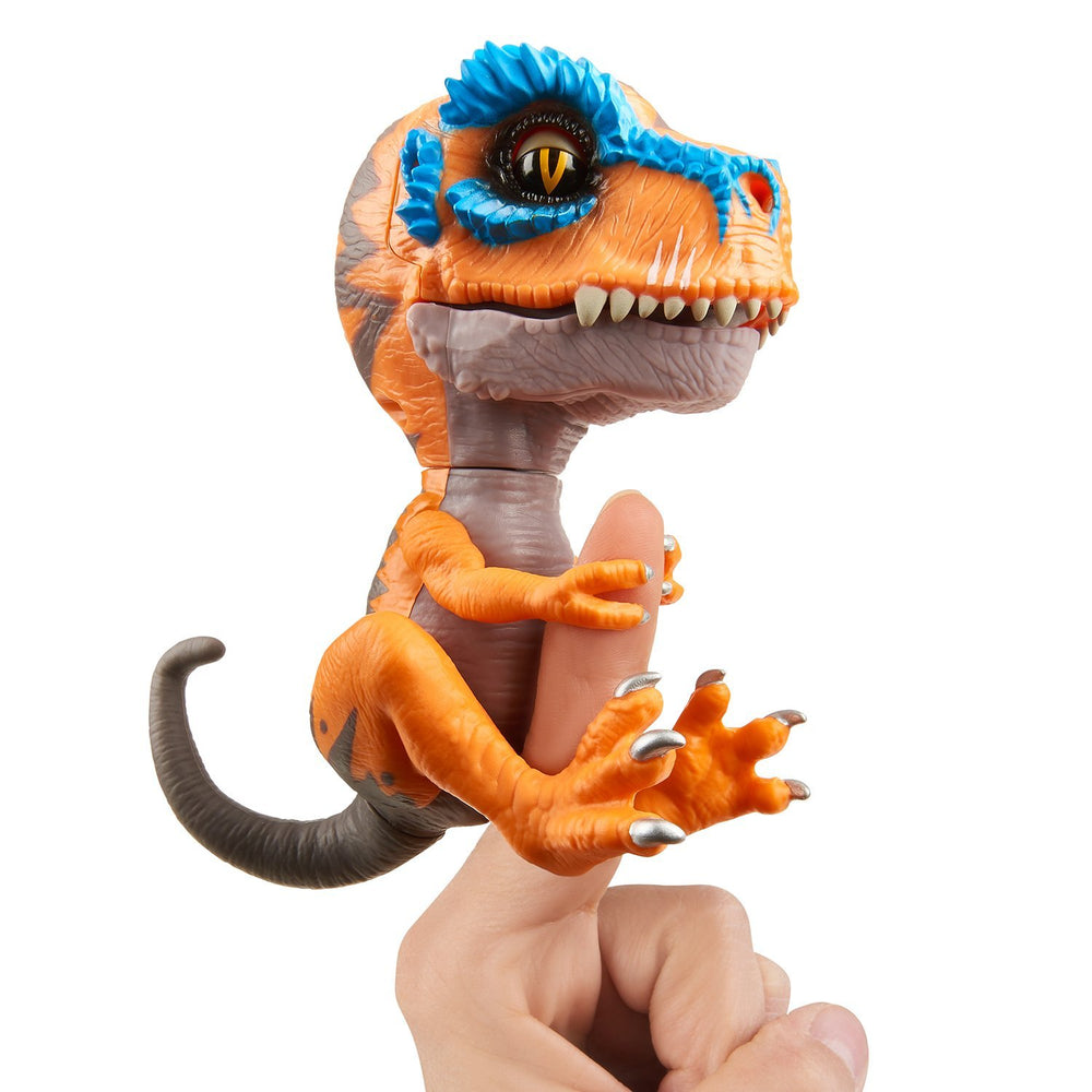 Fingerlings Untamed T-Rex Scratch orange on finger grip in action