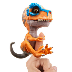 Fingerlings Untamed T-Rex Scratch orange on finger grip in action