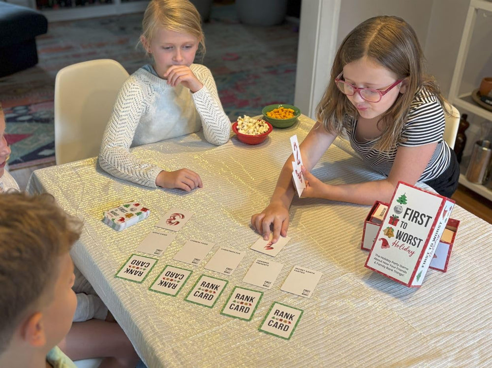 FIRST TO WORST Holiday Edition playing area highlights friends around a table.