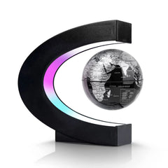 Flagest magnetic levitation globe in a C-shape silver and black frame for modern desk decor.