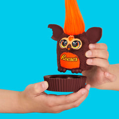 Furby Furblets mini plush sits in a pretend Reese's cup.