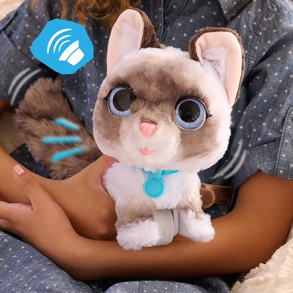 FurReal scale comparison with child hand showing compact, kid-friendly size