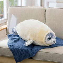 Furvana seal pillow in bedroom decor, adds playful charm to the space.