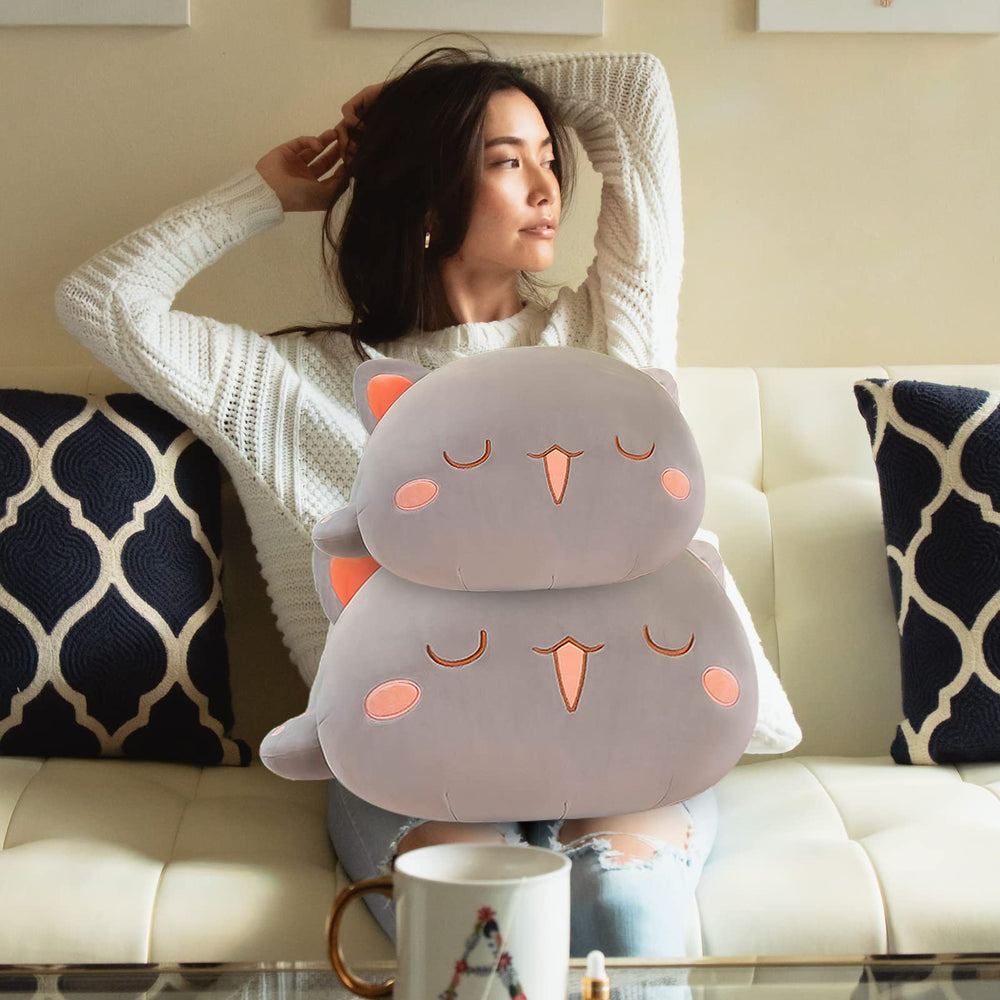 Fuyu cat plush on sofa as playful decor to brighten a room.