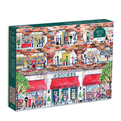 Galison Michael Storrings puzzle box cover shows a cozy bookstore scene perfect for quiet evenings