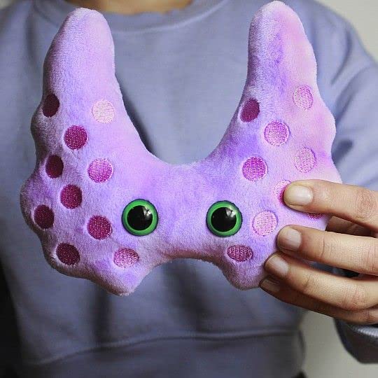 GIANT MICROBES Thyroid Plush held by a caregiver during recovery moments