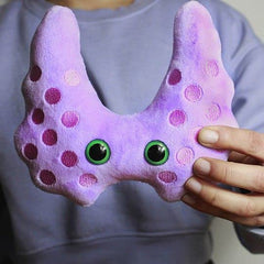 GIANT MICROBES Thyroid Plush held by a caregiver during recovery moments